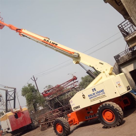 JLG 120HX boom lift with the boom extended and work platform raised