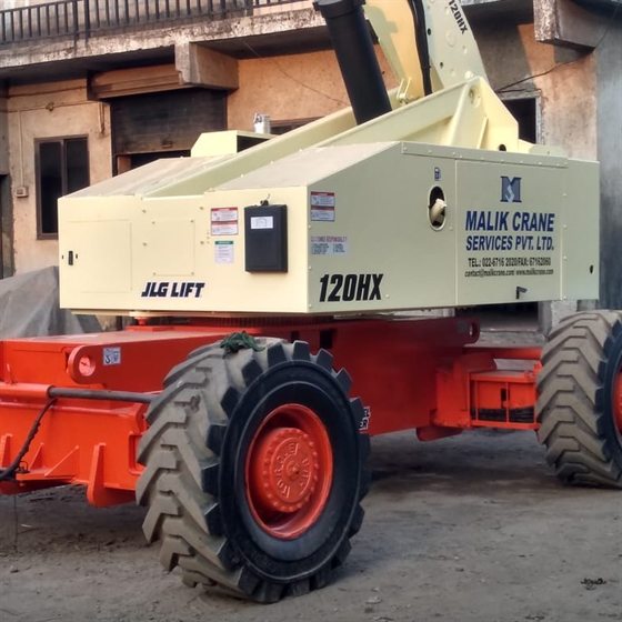 JLG 120HX four-wheel-drive boom lift in Malik Crane Services livery, boom stowed