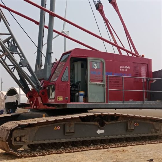 Link-Belt LS-518 crawler crane handling wind turbine components in an open field